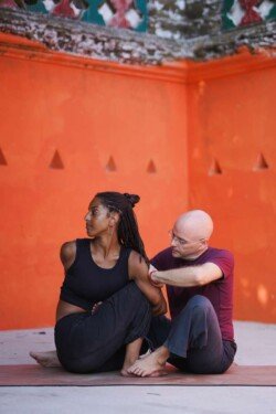Alan che aiuta lo studente a raggiungere la torsione corretta in Marichyasana D (Posizione del saggio Marichi D) nell'Ashtanga Yoga (Prima Serie - Yoga Chikitsa).