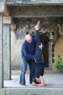 Alan securing the student in Sirsasana (Headstand), an important Ashtanga inversion (Primary Series - Yoga Chikitsa).