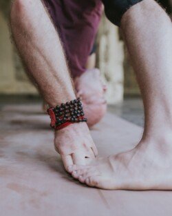 Alan in Prasarita Padottanasana D (Wide-Legged Forward Bend Pose D), detail of Ashtanga Yoga practice (Primary Series - Yoga Chikitsa)