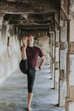 Alan holds Utthita Hasta Padangusthasana (Extended Foot Pose with Hand), perfection in Ashtanga balance (Primary Series - Yoga Chikitsa)